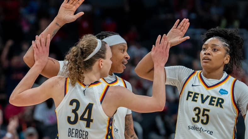 Grace Berger, Emma Cannon and Victoria Vivians celebrate after Berger made a basket during their game against the New York Liberty Wednesday, July 12, 2023 in Gainbridge Fieldhouse in Indianapolis.