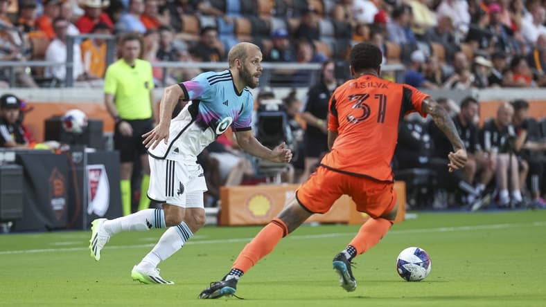 Jul 12, 2023; Houston, Texas, USA; Minnesota United FC forward Teemu Pukki (22) attempts to control the ball as Houston Dynamo FC defender Micael (31) defends during the first half at Shell Energy Stadium. Mandatory Credit: Troy Taormina-USA TODAY Sports
