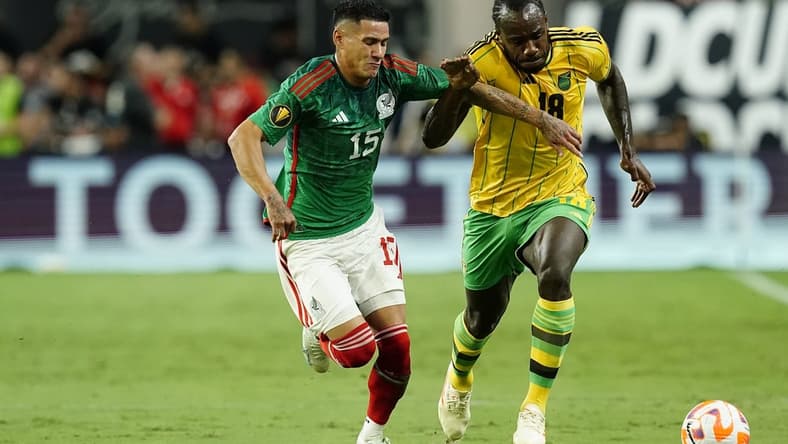 Jul 12, 2023; Las Vegas, Nevada, USA; Mexico forward Uriel Antuna (15) battles for the ball against Jamaica forward Michail Antonio (18) during the first half at Allegiant Stadium. Mandatory Credit: Lucas Peltier-USA TODAY Sports