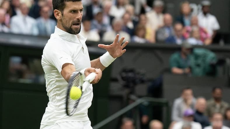 Jul 14, 2023; London, United Kingdom; Novak Djokovic (SRB) returns a shot during his match against Jannik Sinner (ITA) on day 12 at the All England Lawn Tennis and Croquet Club.  Mandatory Credit: Susan Mullane-USA TODAY Sports