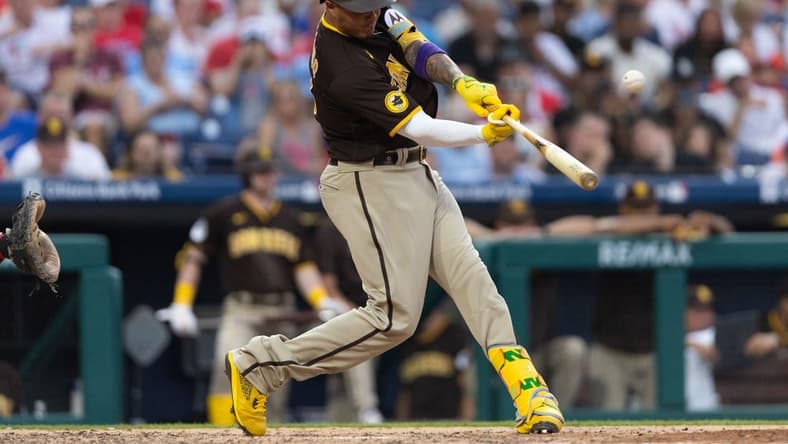 Jul 14, 2023; Philadelphia, Pennsylvania, USA; San Diego Padres third baseman Manny Machado (13) hits a home run during the sixth inning against the Philadelphia Phillies at Citizens Bank Park. Mandatory Credit: Bill Streicher-USA TODAY Sports