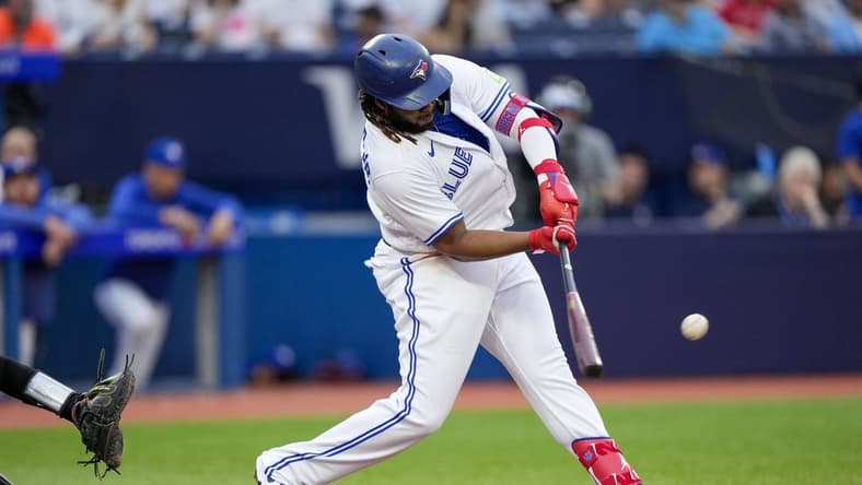 Jul 14, 2023; Toronto, Ontario, CAN; Toronto Blue Jays first baseman Vladimir Guerrero Jr. (27) hits a home run against the Arizona Diamondbacks during the second inning at Rogers Centre. Mandatory Credit: Kevin Sousa-USA TODAY Sports