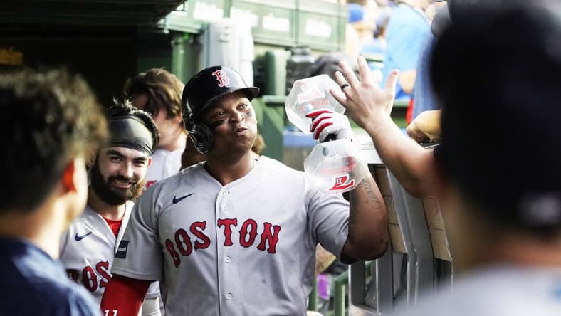 Jul 14, 2023; Chicago, Illinois, USA; Boston Red Sox third baseman Rafael Devers (11) celebrates with teammates in the dugout after hitting a home run against the Chicago Cubs during the third inning at Wrigley Field. Mandatory Credit: David Banks-USA TODAY Sports