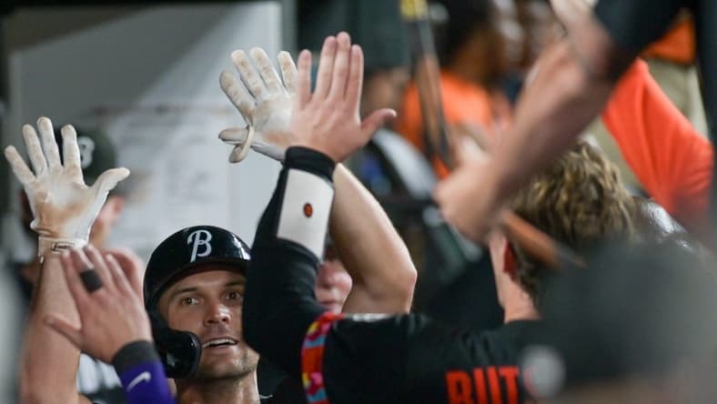 Jul 14, 2023; Baltimore, Maryland, USA; Baltimore Orioles second baseman Adam Frazier (12) high fives teammates after hitting a fourth inning solo home run against the Miami Marlins at Oriole Park at Camden Yards. Mandatory Credit: Tommy Gilligan-USA TODAY Sports