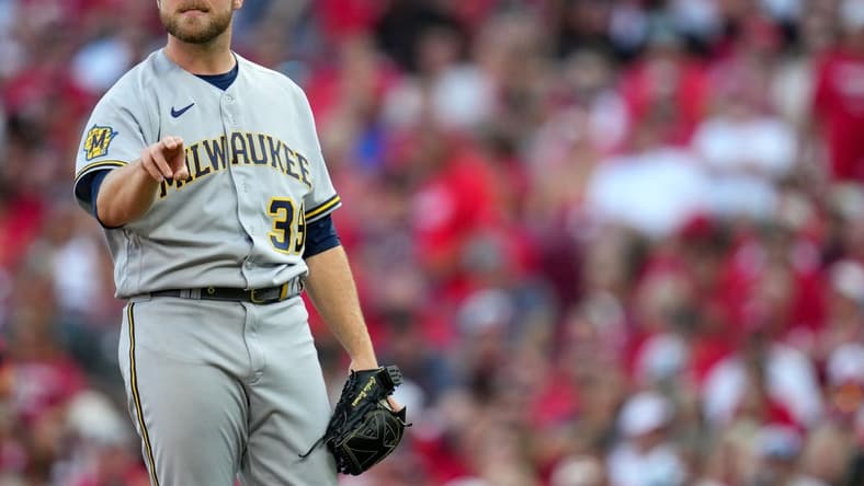 Milwaukee Brewers starting pitcher Corbin Burnes (39) works on his motion during a mound visit in the first inning during a baseball game between the Milwaukee Brewers and the Cincinnati Reds, Friday, July 14, 2023, at Great American Ball Park in Cincinnati.