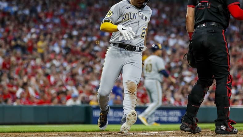 Jul 14, 2023; Cincinnati, Ohio, USA; Milwaukee Brewers shortstop Willy Adames (27) scores on a RBI single hit by catcher Victor Caratini (not pictured) in the seventh inning against the Cincinnati Reds at Great American Ball Park. Mandatory Credit: Katie Stratman-USA TODAY Sports