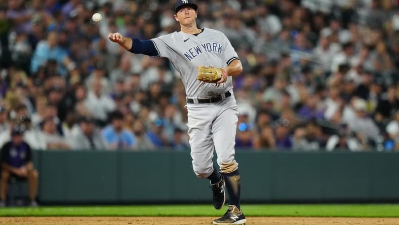 Jul 14, 2023; Denver, Colorado, USA; New York Yankees third baseman DJ LeMahieu (26) fields the ball in the seventh inning against the Colorado Rockies at Coors Field. Mandatory Credit: Ron Chenoy-USA TODAY Sports