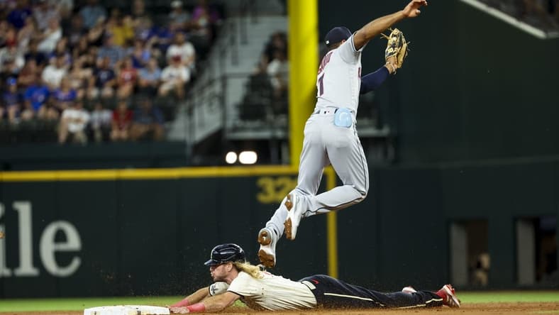 Jul 15, 2023; Arlington, Texas, USA; Texas Rangers left fielder Travis Jankowski (16) slides safely into second base ahead of the tag by Cleveland Guardians shortstop Amed Rosario (1) during the second inning at Globe Life Field. Mandatory Credit: Kevin Jairaj-USA TODAY Sports