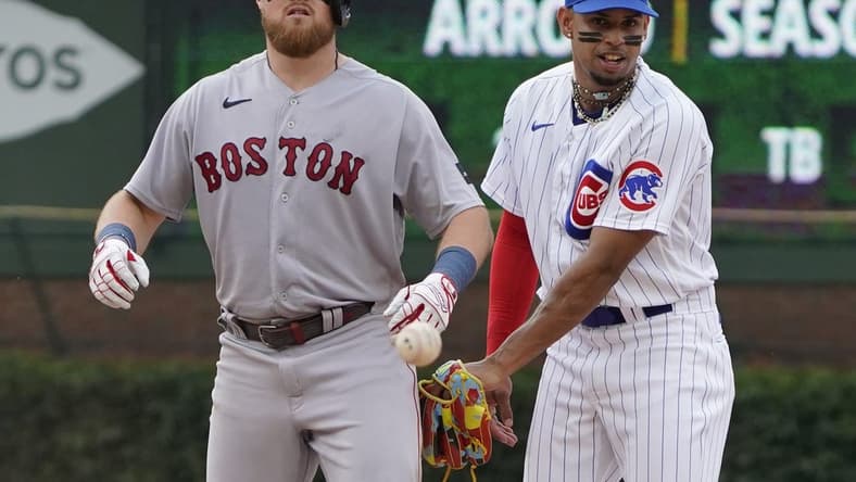 Jul 15, 2023; Chicago, Illinois, USA; Boston Red Sox second baseman Christian Arroyo (39) is safe at second base with a double as Chicago Cubs second baseman Christopher Morel (5) takes the throw during the ninth inning at Wrigley Field. Mandatory Credit: David Banks-USA TODAY Sports