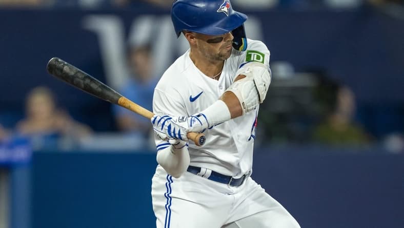 Jul 15, 2023; Toronto, Ontario, CAN; Toronto Blue Jays second baseman Whit Merrifield (15) hits a single during the second inning against the Arizona Diamondbacks at Rogers Centre. Mandatory Credit: Kevin Sousa-USA TODAY Sports