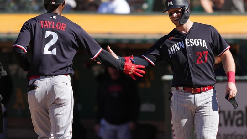 Jul 15, 2023; Oakland, California, USA; Minnesota Twins center fielder Michael A. Taylor (2) celebrates with catcher Ryan Jeffers (27) after hitting a home run against the Oakland Athletics during the third inning at Oakland-Alameda County Coliseum. Mandatory Credit: Darren Yamashita-USA TODAY Sports