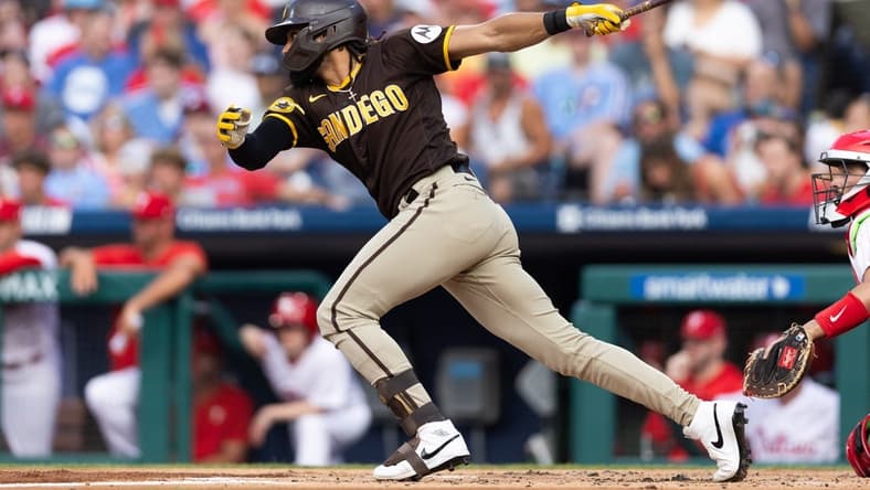 Jul 15, 2023; Philadelphia, Pennsylvania, USA; San Diego Padres right fielder Fernando Tatis Jr. (23) hits an RBI fielders choice during the first inning against the Philadelphia Phillies at Citizens Bank Park. Mandatory Credit: Bill Streicher-USA TODAY Sports