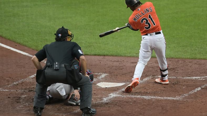 Jul 15, 2023; Baltimore, Maryland, USA; Baltimore Orioles center fielder Cedric Mullins (31) hits a rbi single scoring first baseman Ryan Mountcastle (not pictured) during the second inning against the Miami Marlins at Oriole Park at Camden Yards. Mandatory Credit: Tommy Gilligan-USA TODAY Sports
