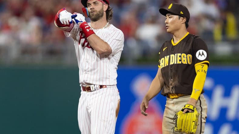 Jul 15, 2023; Philadelphia, Pennsylvania, USA; Philadelphia Phillies designated hitter Bryce Harper (3) reacts next to San Diego Padres second baseman Ha-Seong Kim (7) after hitting a double during the fifth inning at Citizens Bank Park. Mandatory Credit: Bill Streicher-USA TODAY Sports
