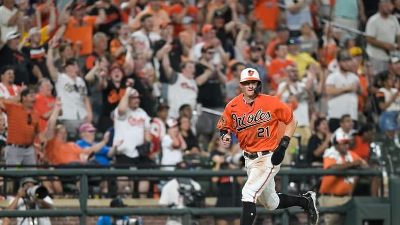 Jul 15, 2023; Baltimore, Maryland, USA; Baltimore Orioles left fielder Austin Hays (21) scores on right fielder Anthony Santander (not pictured) seventh inning single against the Miami Marlins at Oriole Park at Camden Yards. Mandatory Credit: Tommy Gilligan-USA TODAY Sports