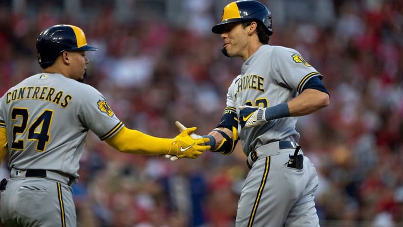 Milwaukee Brewers designated hitter Christian Yelich (22) celebrates with Milwaukee Brewers catcher William Contreras (24) after hitting a solo home run in the first inning of the MLB baseball game between the Cincinnati Reds and the Milwaukee Brewers at Great American Ball Park in Cincinnati on Saturday, July 15, 2023.
