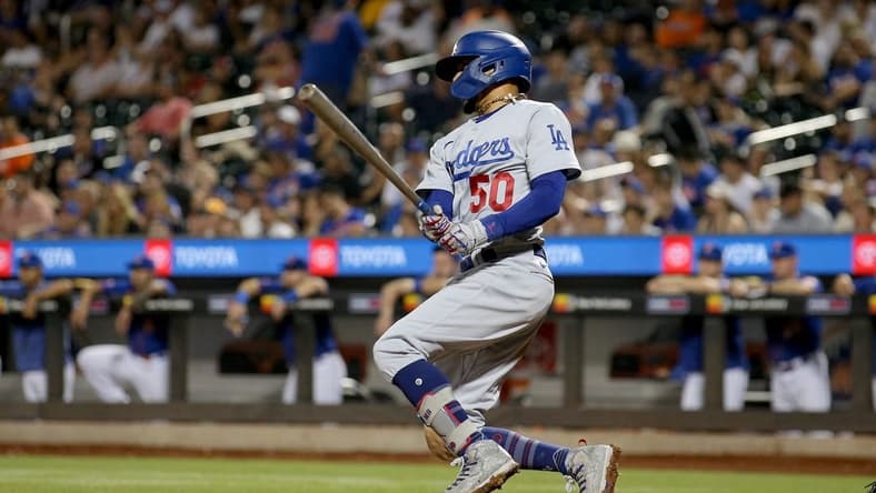 Jul 15, 2023; New York City, New York, USA; Los Angeles Dodgers second baseman Mookie Betts (50) follows through on a single against the New York Mets during the ninth inning at Citi Field. Mandatory Credit: Brad Penner-USA TODAY Sports