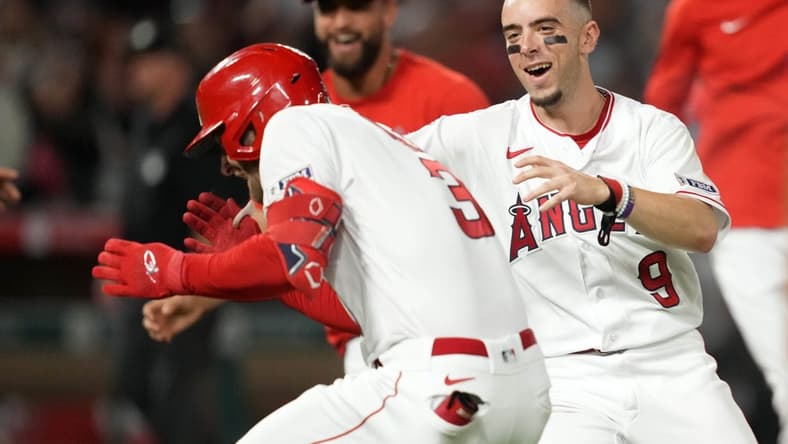 Jul 15, 2023; Anaheim, California, USA; Los Angeles Angels left fielder Taylor Ward (3) celebrates with shortstop Zach Neto (9) after hitting a fielder choice ground ball in the 10th inning to drive in the winning run against the Houston Astros at Angel Stadium. Mandatory Credit: Kirby Lee-USA TODAY Sports