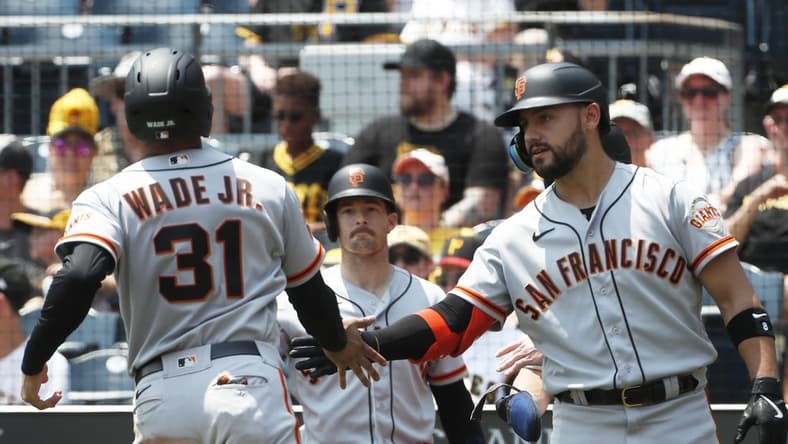Jul 16, 2023; Pittsburgh, Pennsylvania, USA; San Francisco Giants right fielder Michael Conforto (8) greets first baseman LaMonte Wade Jr. (31) crossing home plate to score a run against the Pittsburgh Pirates during the third inning at PNC Park. Mandatory Credit: Charles LeClaire-USA TODAY Sports