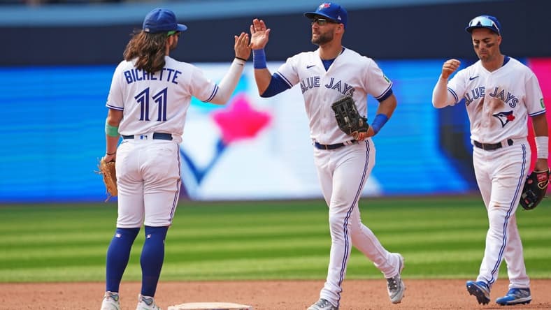 Jul 16, 2023; Toronto, Ontario, CAN; Toronto Blue Jays shortstop Bo Bichette (11) and center fielder Kevin Kiermaier (39) celebrate the win at the end of the ninth inning against the Arizona Diamondbacks at Rogers Centre. Mandatory Credit: Nick Turchiaro-USA TODAY Sports