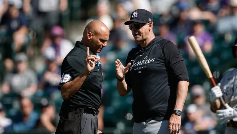 Jul 16, 2023; Denver, Colorado, USA; New York Yankees manager Aaron Boone (17) talks with home plate umpire Vic Carapazza (19) in the ninth inning against the Colorado Rockies at Coors Field. Mandatory Credit: Isaiah J. Downing-USA TODAY Sports
