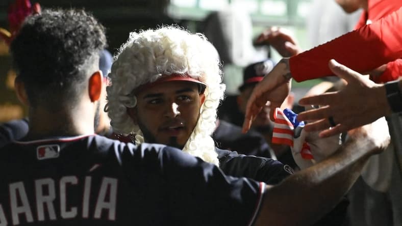 Jul 17, 2023; Chicago, Illinois, USA; Washington Nationals catcher Keibert Ruiz (20) celebrates in the dugout after hitting a two-run home run against the Chicago Cubs during the seventh inning at Wrigley Field. Mandatory Credit: Matt Marton-USA TODAY Sports