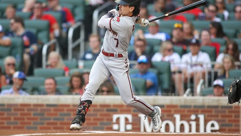 Jul 18, 2023; Atlanta, Georgia, USA; Arizona Diamondbacks right fielder Corbin Carroll (7) hits a RBI triple against the Atlanta Braves in the first inning at Truist Park. Mandatory Credit: Brett Davis-USA TODAY Sports