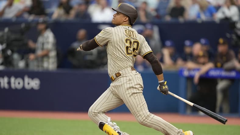 Jul 18, 2023; Toronto, Ontario, CAN;  San Diego Padres left fielder Juan Soto (22) hits a two run home run against the Toronto Blue Jays during the first inning at Rogers Centre. Mandatory Credit: John E. Sokolowski-USA TODAY Sports