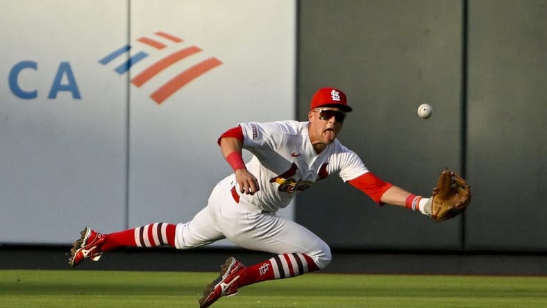 Jul 18, 2023; St. Louis, Missouri, USA; St. Louis Cardinals center fielder Lars Nootbaar (21) dives and catches a line drive hit by Miami Marlins center fielder Dane Myers (not pictured) during the second inning at Busch Stadium. Mandatory Credit: Jeff Curry-USA TODAY Sports