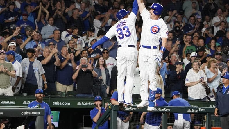 Jul 18, 2023; Chicago, Illinois, USA; Chicago Cubs third baseman Patrick Wisdom (16) is greeted by Chicago Cubs third base coach Willie Harris (33) after hitting a home run against the Washington Nationals during the seventh inning at Wrigley Field. Mandatory Credit: David Banks-USA TODAY Sports