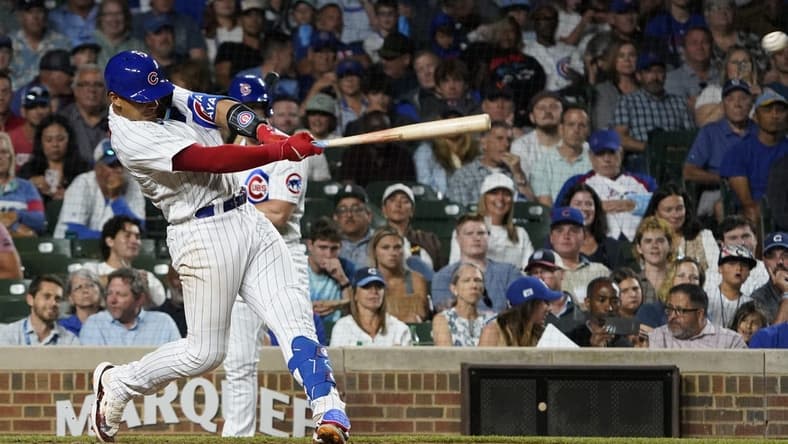 Jul 18, 2023; Chicago, Illinois, USA; Chicago Cubs catcher Miguel Amaya (6) hits a two-run single against the Washington Nationals during the seventh inning at Wrigley Field. Mandatory Credit: David Banks-USA TODAY Sports