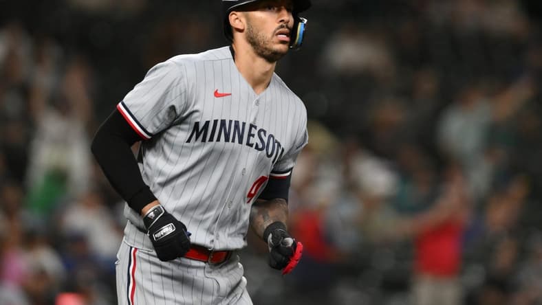 Jul 18, 2023; Seattle, Washington, USA; Minnesota Twins shortstop Carlos Correa (4) runs toward first base after hitting a home run against the Seattle Mariners during the ninth inning at T-Mobile Park. Mandatory Credit: Steven Bisig-USA TODAY Sports
