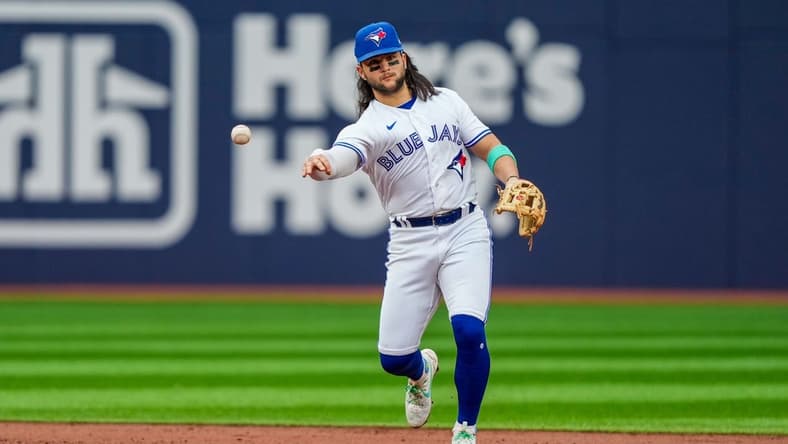 Jul 14, 2023; Toronto, Ontario, CAN; Toronto Blue Jays shortstop Bo Bichette (11) throws to first against the Arizona Diamondbacks  at Rogers Centre. Mandatory Credit: Kevin Sousa-USA TODAY Sports