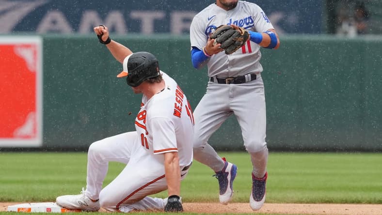 Jul 19, 2023; Baltimore, Maryland, USA; Los Angeles Dodgers shortstop Miguel Rojas (11) gets a force out on Baltimore Orioles second baseman Jordan Westburg (11) in the second inning at Oriole Park at Camden Yards. Mandatory Credit: Mitch Stringer-USA TODAY Sports