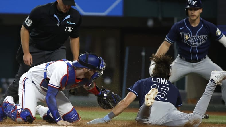 Jul 19, 2023; Arlington, Texas, USA; Texas Rangers catcher Jonah Heim (28) tags Tampa Bay Rays designated hitter Josh Lowe (15) out at home plate in the second inning at Globe Life Field. Mandatory Credit: Tim Heitman-USA TODAY Sports