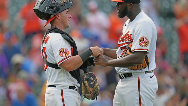 Jul 19, 2023; Baltimore, Maryland, USA; Baltimore Orioles pitcher Felix Bautista (right) greets catcher James McCann (left) after earning a save against the Los Angeles Dodgers at Oriole Park at Camden Yards. Mandatory Credit: Mitch Stringer-USA TODAY Sports