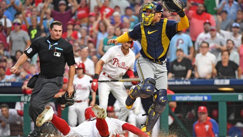 Jul 19, 2023; Philadelphia, Pennsylvania, USA; Philadelphia Phillies center fielder Brandon Marsh (16) slides safely into home as Milwaukee Brewers catcher William Contreras (24) moves out of the way during the fifth inning at Citizens Bank Park. Mandatory Credit: Eric Hartline-USA TODAY Sports