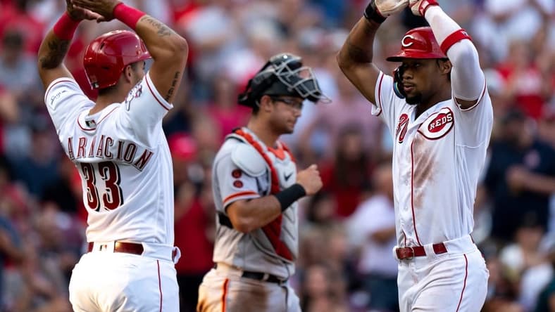 Cincinnati Reds left fielder Will Benson (30) high fives Cincinnati Reds first baseman Christian Encarnacion-Strand (33) after hitting a 3-run home run in the third inning of the baseball game between the Cincinnati Reds and San Francisco Giants at Great American Ball Park in Cincinnati on Wednesday, July 19, 2023.