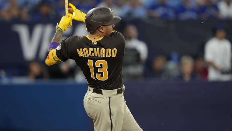 Jul 19, 2023; Toronto, Ontario, CAN; San Diego Padres third baseman Manny Machado (13) breaks his bat on a two run single against the Toronto Blue Jays during the fifth inning at Rogers Centre. Mandatory Credit: John E. Sokolowski-USA TODAY Sports