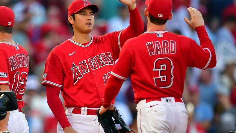 Jul 19, 2023; Anaheim, California, USA; Los Angeles Angels designated hitter Shohei Ohtani (17) and left fielder Taylor Ward (3) celebrate the victory against the New York Yankees at Angel Stadium. Mandatory Credit: Gary A. Vasquez-USA TODAY Sports