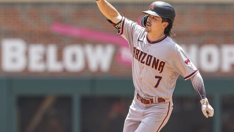 Jul 20, 2023; Cumberland, Georgia, USA; Arizona Diamondbacks left fielder Corbin Carroll (7) reacts after hitting a home run against the Atlanta Braves during the eighth inning at Truist Park. Mandatory Credit: Dale Zanine-USA TODAY Sports