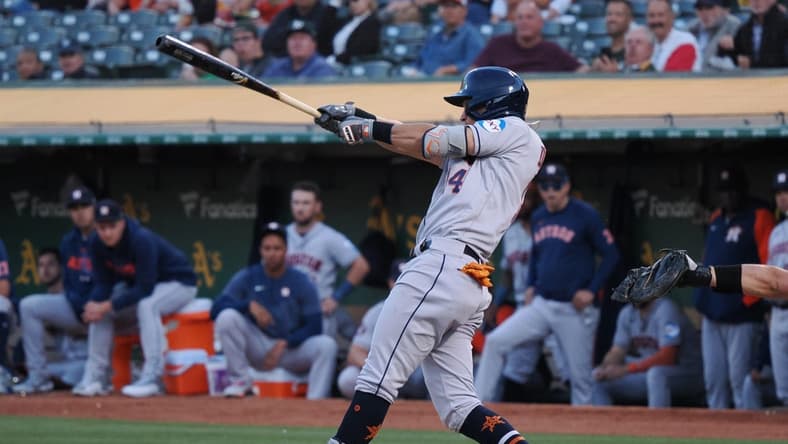 Jul 20, 2023; Oakland, California, USA; Houston Astros second baseman Mauricio Dubon (14) hits a single against the Oakland Athletics during the sixth inning at Oakland-Alameda County Coliseum. Mandatory Credit: Kelley L Cox-USA TODAY Sports