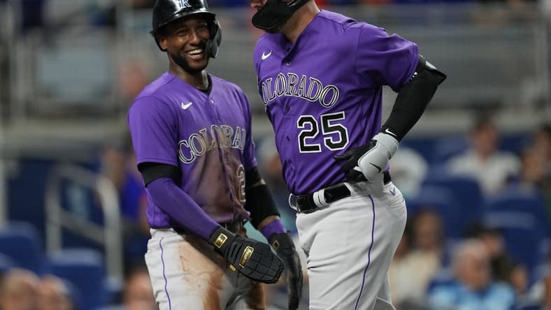 Jul 21, 2023; Miami, Florida, USA;  Colorado Rockies first baseman C.J. Cron (25) is congratulated by left fielder Jurickson Profar (29) after hitting a two-run home run in the first inning against the Miami Marlins at loanDepot Park. Mandatory Credit: Jim Rassol-USA TODAY Sports