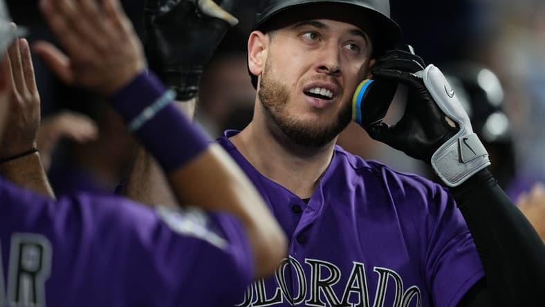 Jul 21, 2023; Miami, Florida, USA; Colorado Rockies first baseman C.J. Cron (25) is congratulated after hitting a two-run home run in the first inning against the Miami Marlins at loanDepot Park. Mandatory Credit: Jim Rassol-USA TODAY Sports
