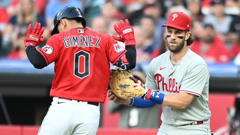 Jul 21, 2023; Cleveland, Ohio, USA; Philadelphia Phillies first baseman Bryce Harper (3) tags out Cleveland Guardians second baseman Andres Gimenez (0) during the fourth inning at Progressive Field. Mandatory Credit: Ken Blaze-USA TODAY Sports