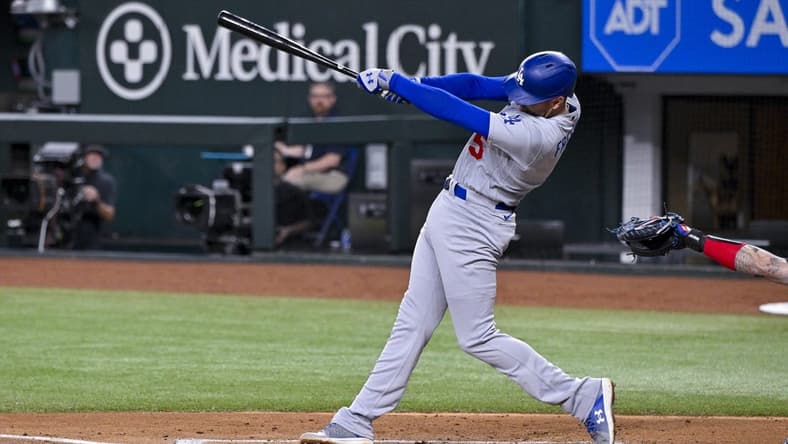 Jul 21, 2023; Arlington, Texas, USA; Los Angeles Dodgers first baseman Freddie Freeman (5) hits a double and drives in two runs against the Texas Rangers during the third inning at Globe Life Field. Mandatory Credit: Jerome Miron-USA TODAY Sports