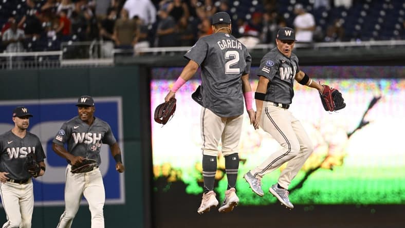 Jul 21, 2023; Washington, District of Columbia, USA; Washington Nationals center fielder Alex Call (17) celebrates with second baseman Luis Garcia (2) after the game against the San Francisco Giants at Nationals Park. Mandatory Credit: Brad Mills-USA TODAY Sports