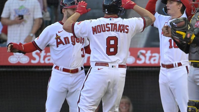 Jul 21, 2023; Anaheim, California, USA; Los Angeles Angels first baseman Mike Moustakas (8) hit a three-run home run scoring left fielder Taylor Ward (3) and right fielder Mickey Moniak (16) in the fourth inning against the Pittsburgh Pirates at Angel Stadium. Mandatory Credit: Jayne Kamin-Oncea-USA TODAY Sports