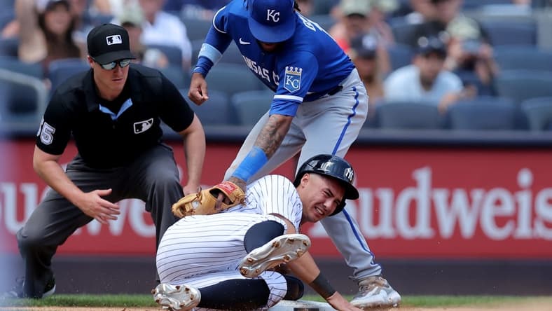 Jul 22, 2023; Bronx, New York, USA; New York Yankees shortstop Anthony Volpe (11) steals third base ahead of a tag by Kansas City Royals third baseman Maikel Garcia (11) during the third inning at Yankee Stadium. Mandatory Credit: Brad Penner-USA TODAY Sports