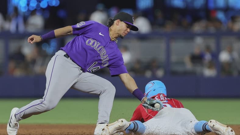 Jul 22, 2023; Miami, Florida, USA; Miami Marlins left fielder Jon Berti (5) steals second base against Colorado Rockies shortstop Ezequiel Tovar (14) during the seventh inning at loanDepot Park. Mandatory Credit: Sam Navarro-USA TODAY Sports